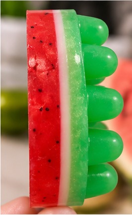 Side view of a handmade watermelon massage bar soap