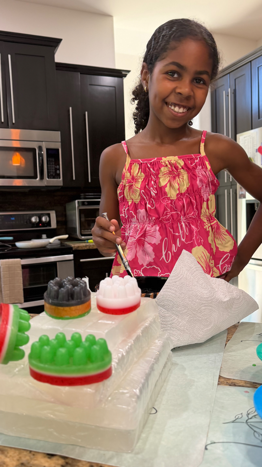 Ava smiling while making colorful massage bar soaps